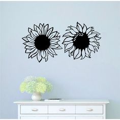 two large sunflowers are shown on the wall