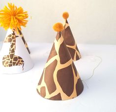 two giraffe print party hats with orange flowers