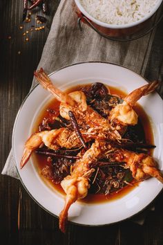 a white plate topped with shrimp and rice