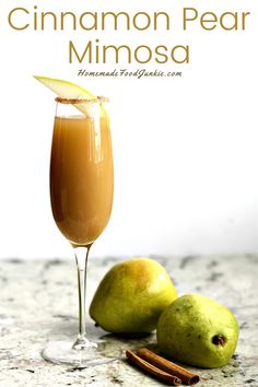 cinnamon pear mimosa in a glass next to two pears