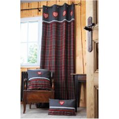 the curtains in this room are red, black and gray plaid with hearts on them