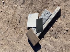 three pieces of stone sitting on the ground