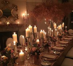 a long table is set with candles and place settings for an elegant dinner or party