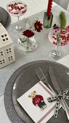 a table set for christmas with silverware and decorations