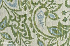 close up view of the fabric with green and blue flowers on it