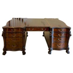 an antique desk with two drawers on each side