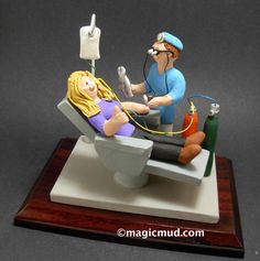 a figurine of a dentist examining a patient