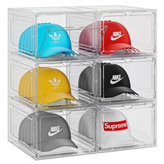 four clear bins with hats in them and the words supreme written on one side