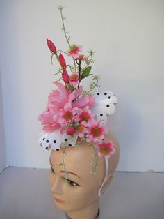 "* This pleated polka dot hat base has a 8\" diameter featuring an open pink silk peony, open roses, closed tulips and summer greens. * White millinery netting hides the underside of the hat base form and adds just a touch of texture variety and drama to the piece. * On a metal headband with a satin ribbon covering it is secure, well balanced and comfortable to wear for extended periods of time. * Upon ordering you will receive this exact headpiece. * Perfect for the Kentucky Derby or any other Spring Flower Hats For Races, Spring Mini Hats With Handmade Flowers For Races, Spring Races Flower Hat, Handmade Flower Mini Hats For Spring Races, Spring Mini Hat With Handmade Flowers For Races, Pink Spring Headpiece With Handmade Flowers, Whimsical Fitted Fascinator For Spring, Spring Pink Headpiece With Handmade Flowers, Fitted Whimsical Spring Fascinator