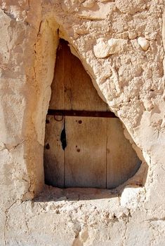 an old wooden door in the side of a stone building