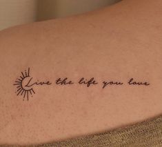 a woman's arm with a tattoo saying live the life you love