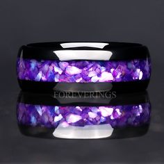 a purple and black wedding band with amethorate stones inlayed to it