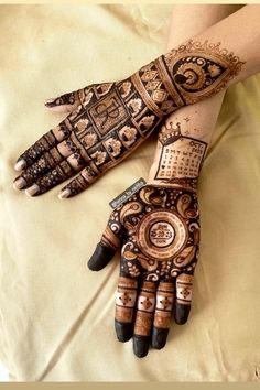 two hands with henna designs on them