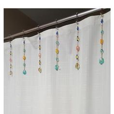 a shower curtain with beads hanging from it