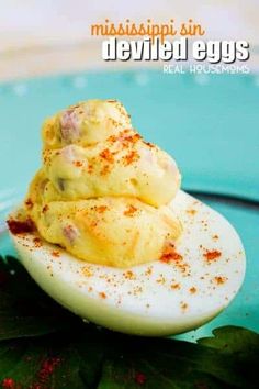 deviled eggs on a plate topped with seasoning