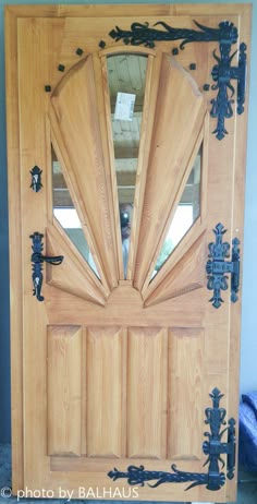 a wooden door with metal decorations on it