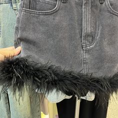 Introducing the 2023 Spring-Summer Collection's feather-trimmed mini denim skirt. a vintage-style masterpiece perfect for the modern fashionista!Why You'll Fall In LoveThis skirt is the ideal combination of the iconic Y2K style with today's fashion. boasting a mid-waist fit. a zipper and button closure. and a unique sanded finish. Every detail of this skirt is designed to make sure you stand out from the crowd and keep you looking chic and stylish.Unmissable Highlights: Y2K Inspired: Get ready t Highlights Y2k, Jean Jacket Patches, Iconic Y2k, Mini Denim Skirt, Street Trends, Black Sand, Slim Jeans, Y2k Style, Easy Wear