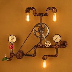 a steam clock made out of pipes and gauges hanging from the ceiling with light bulbs on either side