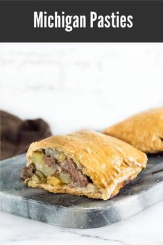 two pastries sitting on top of a metal pan with the words michigan pasties