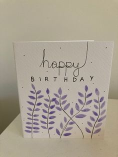 a birthday card with purple flowers on it