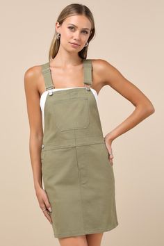 Show off your adorable aesthetic all over town in the Lulus Cutest Spirit Olive Green Twill Overall Mini Dress With Pockets! Slightly stretchy twill shapes this trendy dress with an apron neckline, a bib-style bodice with a large front pocket, and wide adjustable straps that create a modified racerback design at the back. A banded waist sits atop a mini skirt with front diagonal pockets and buttons that secure at the sides. Silver hardware throughout. Fit: This garment fits true to size. Length: Green Overall Dress, White Mock Neck Top, White Mock Neck, Denim Overall Dress, A Line Mini Skirt, Everyday Dresses, Overall Dress, Dress Outfit, Trendy Dresses