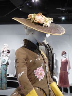 mannequins in dresses and hats with flowers on them