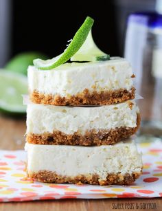 three pieces of cheesecake stacked on top of each other with a lime slice in the middle