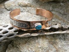 This is a beautiful Handcrafted Native American Made Copper With Sterling Silver Overlay Cuff Bracelet. The cuff is entirely Handcrafted which makes it a ONE OF A KIND. You get the EXACT bracelet cuff shown. This also has a Turquoise cabochon set in Sterling Silver to add a little bit more beauty to this design. This cuff is meticulously handcrafted by LC Littl a Native American Navajo silversmith, and the quality and attention to detail is truly exceptional. Get all the befits of wearing a copper bracelet, but also enjoying wearing a unique work of art! The Silversmith workmanship makes this bracelet a beautiful high quality handmade masterpiece. This is a nice size and will fit most average size wrist perfect for layering or wear it alone. The Opening is about 1.5 inches and can be adjus Southwestern Turquoise Cuff Bracelet As Gift, Southwestern Style Turquoise Cuff Bracelet As Gift, Turquoise Southwestern Cuff Bracelet As Gift, Southwestern Style Turquoise Cuff Bracelet For Gifts, Southwestern Inlay Cuff Bracelet Gift, Southwestern Engraved Cuff Bracelet As A Gift, Western Style Blue Cuff Bracelet Gift, Stamped Turquoise Bracelet As Gift, Handmade Western Style Cuff Bracelet