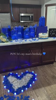 a kitchen counter with blue and white decorations in the shape of a heart on it