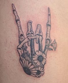 a tattoo design with flowers and sticks in the shape of a hand holding two fingers