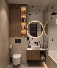 a bathroom with a toilet, sink and mirror in it's center wall is lit by recessed lighting