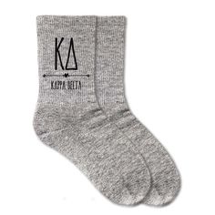 a pair of grey socks with the word ata on it and an arrow in black