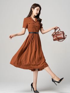 "This stunning brown shirt dress is a versatile piece that can be dressed up or down depending on the occasion. Featuring elegant pleats, this dress is perfect for both work and play. The short sleeves make it perfect for warmer weather, while the brown color gives it a classic look that will never go out of style. Pair it with heels for a sophisticated office look or sandals for a casual day out. DETAIL * The brown dress contain 50% polyester, others are nylon,fiber * Has no pockets * Right sid Office Lady Style Dress With Button Closure For Spring, Brown Summer Dresses With Buttons, Brown Buttoned Summer Dresses, Chic Brown Knee-length Midi Dress, Brown A-line Dress With Buttons, Summer Collared Single Breasted Dress, Summer Collared Single-breasted Dress, Semi-formal Button-up Dresses With Pockets, Single Breasted Knee-length Summer Dress