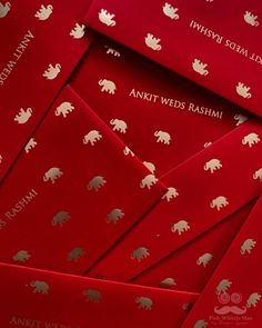 red envelopes with silver elephants on them and the words annitt weds rasami