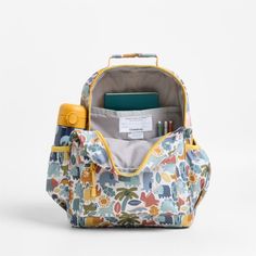 A backpack that's extra comfy and ready to handle all the adventures of the day. Decorated with colorful dino pals, a lush landscape and cheery yellow trim, this kids' medium knapsack is constructed of supremely durable polyester fabric that includes recycled plastic bottles. A roomy interior holds everything your kid needs-books, school supplies, extra layers-and there's a padded pocket to keep their tablet protected. Outside pockets hold snacks, water bottles and more. Pair this book bag with Playful Outdoor Backpack, Playful Backpack For End Of School Year Outdoor Use, Yellow Backpack For Outdoor Activities And Back To School, Yellow Backpack For Back To School With Zipper, Back To School Yellow Backpack For Outdoor Activities, Back To School Yellow Backpack With Zipper Closure, Back To School Yellow Backpack With Zipper, Playful Yellow Backpack For Back To School, Casual Backpack For Daycare And Back To School