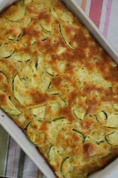 a casserole dish with zucchini bread in it and the title overlay reads, parmesan zucchini bread perfect summer side dish