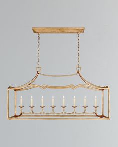 a chandelier with five candles hanging from it's center and four arms