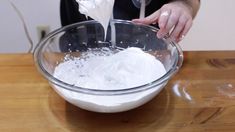 a person pouring white liquid into a bowl