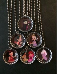 six bottle caps with disney characters on them hanging from a silver ball chain, set against a black background