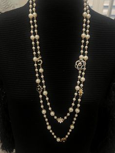 Beautiful Pearl Camellia necklace, a piece that embodies timeless beauty and sophistication. Each lustrous pearl is meticulously selected for its radiant sheen and flawless surface, ensuring that every necklace is a masterpiece. Available in black or white camellia flower. Elegant Pearl Chain Flower Necklace, Elegant Flower Necklace With Pearl Chain, Elegant Flower-shaped Pearl Chain Necklace, Elegant Pearl Flower Necklace, Elegant Flower Pendant Necklace, Floral Pearl Charm Jewelry, Elegant Pearl Flower Necklace With Pearl Chain, Floral Pearl Chain Jewelry, Elegant Long Pearl Pendant Necklace