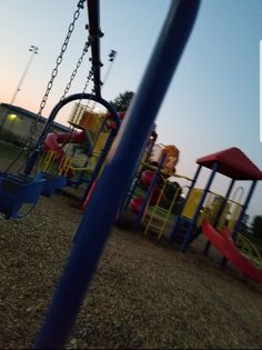 an empty playground with swings and slides