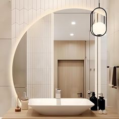 a bathroom with a sink, mirror and light fixture in it's center area