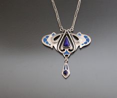 Jugendstil DEPOSE 900 Silver, Lapis Lazuli, Enamel Pendant Necklace. Antique Art Nouveau Jewelry Jugendstil 900 silver necklace. 1900 - 1910's, Pforzheim, Germany. No maker's mark. Clasp in non-precious metal. Tested and hallmarked in Czech Assay Office (2024). Very good antique condition.  With no dents or loses.  Stones intact. Enamel intact. Barrel clasp closure (brass) works fine. Pendant:   1 5/8" 1 3/4"    (41 x 45mm).  Chain from end to end: 17 3/4"   (45cm). Weight:  9,85g. * * * All our Brass Pendant Necklace, Bijoux Art Nouveau, Victorian Locket, Art Nouveau Pendant, Nouveau Jewelry, Necklace Antique, Art Nouveau Jewelry, Wood Jewelry, Geometric Necklace