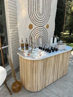 an outdoor bar with bottles and glasses on it