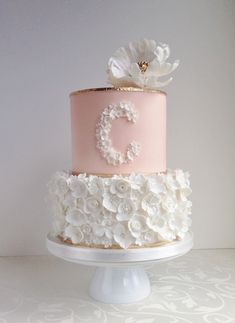 a three tiered cake with white flowers on top