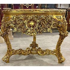 an ornate gold console table in a store