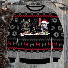 an ugly christmas sweater with star wars characters on it, sitting next to pine cones