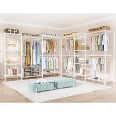 a white closet filled with lots of different types of shirts and pants on shelves next to a rug