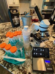 a kitchen counter topped with lots of different types of utensils and beakles