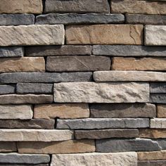 a stone wall made out of several different types of stones, including gray and brown